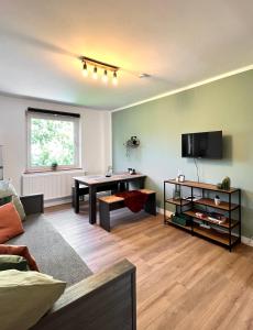 - un salon avec une table et un bureau dans l'établissement Sali - R6 - Apartmenthaus, WLAN, TV, à Remscheid