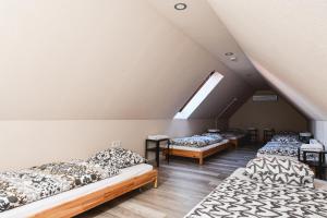 a room with four beds in a attic at Végvári Hotel Eger in Eger