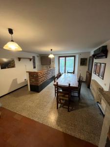 a dining room with a table and chairs in a room at Abetone Pian di Novello - trekking hut in Pian di Novello