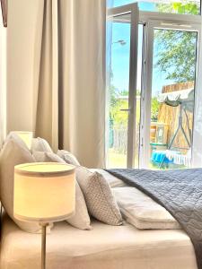 a bedroom with a bed and a large window at Maria Apartments - Free Parking in Prague