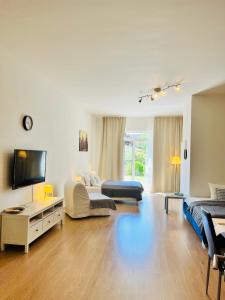 a large living room with two beds and a tv at Maria Apartments - Free Parking in Prague