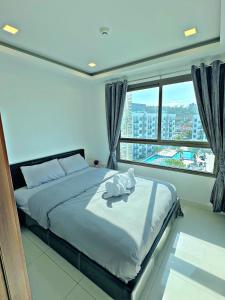 Postel nebo postele na pokoji v ubytování Arcadia beach resort Pattaya + 21 fotografií