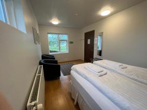 アークレイリにあるGlæsibær 2 Guesthouse and horsefarmのベッド2台と窓が備わるホテルルームです。