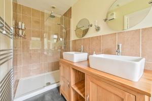 a bathroom with a white sink and a shower at Riverside B&B in Moretonhampstead