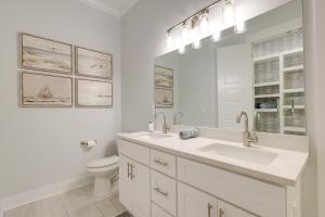 a white bathroom with a sink and a toilet at Bright Foley Home with Patio - 7 Mi to Wharf and Beach in Foley +21 photos