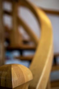 a close up of a wooden chair in a room at Tatryhome - dom in Veľký Slavkov