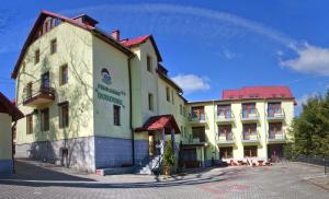 a building with a sign on the side of it at Pensjonat Borowik in Jagniątków