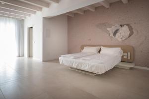 Un ou plusieurs lits dans un hébergement de l'établissement Unico Hotel Caorle
