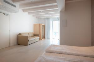 Un ou plusieurs lits dans un hébergement de l'établissement Unico Hotel Caorle