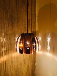 a pendant light hanging from a wall next to a tub at Reine Retro Villa - Cozy Villa With a Fantastic View in Reine