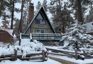 a cabin in the woods in the snow at The Getaway - Amazing and cozy escape! With beautiful views of the Bear Mountain slopes! in Big Bear Lake