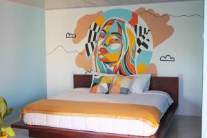 a bedroom with a mural of a woman at Living Room in Fortuna