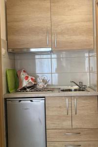 a small kitchen with a stove and a sink at Apartments by the sea Drasnice, Makarska - 15927 in Drasnice