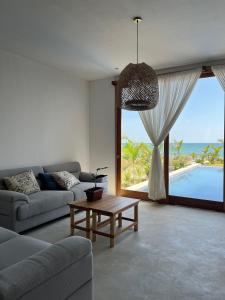 ein Wohnzimmer mit einem Sofa und einem Tisch in der Unterkunft Casa GAIA - Punta Sal in Canoas De Punta Sal