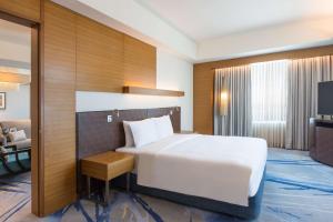 a hotel room with a bed and a television at Radisson Blu Cebu in Cebu City