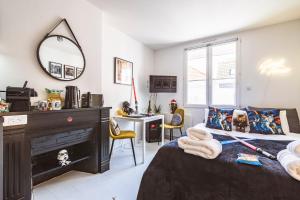 a bedroom with a bed with a fireplace and a mirror at ExploreReims - Studio intergalactique chic proche gare/centre in Reims