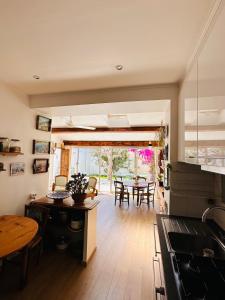 a kitchen and dining room with a table and chairs at Le jardin du roucas in Marseille