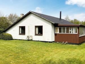 a white house with two dogs in front of it at 6 person holiday home in Nørre Nebel-By Traum in Nørre Nebel