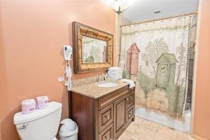 a bathroom with a sink and a toilet at Bear family Ranch - Perfect for groups! ideal location for stargazing and sky watching! in Big Bear City +45 photos