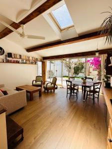 a living room with a table and a couch at Le jardin du roucas in Marseille