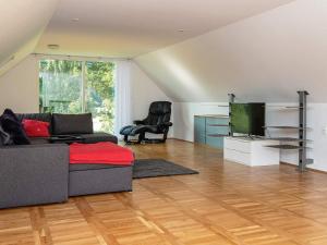 a living room with a couch and a flat screen tv at Holiday home Galten in Galten
