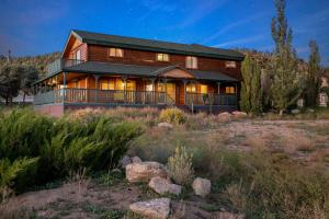 a large wooden house in the middle of a field at Bear family Ranch - Perfect for groups! ideal location for stargazing and sky watching! in Big Bear City
