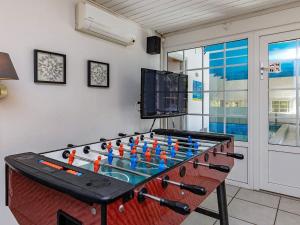 a foosball table in a living room with a tv at 12 person holiday home in V ggerl se in Marielyst