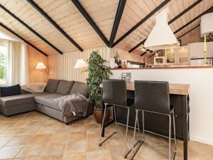 a living room with a couch and a table at 6 person holiday home in Væggerløse-By Traum in Marielyst +45 photos