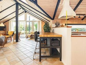 a kitchen and living room with a table and chairs at 6 person holiday home in Væggerløse-By Traum in Marielyst