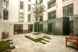 a courtyard in a building with two benches at 1BR near Central Restaurant in Barranco by Wynwood House in Lima +25 photos