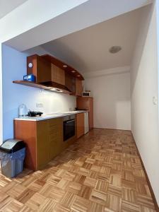 an empty kitchen with wooden flooring in a room at Apartma Lunca 2 in Ljubljana