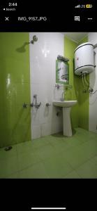 a green bathroom with a sink and a toilet at OYO Flagship 89130 Kohsheen Guest House 