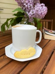filiżankę kawy na talerzu z drewnianą łyżką w obiekcie Stanica Wodna Płaska w Płaskiej