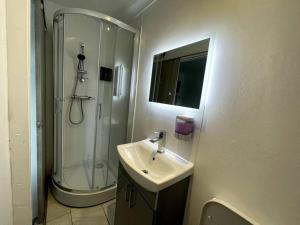 a bathroom with a sink and a shower at Chic 2 Bedroom Flat in Trimley Heath