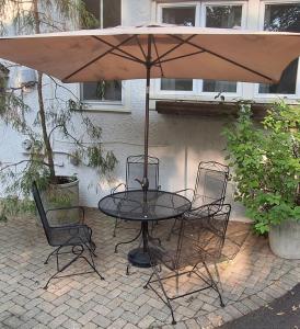 a table and chairs under an umbrella on a patio at Historic Oak Park Residence in Oak Park
