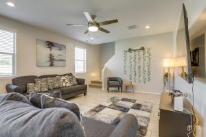 a living room with two couches and a ceiling fan at Spacious Avondale Home with Patio and Pool Access! in Avondale
