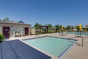 a large swimming pool with chairs at Spacious Avondale Home with Patio and Pool Access! in Avondale