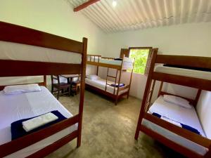 a room with three bunk beds and a window at Pousada Serra do Camulengo in Barra da Estiva