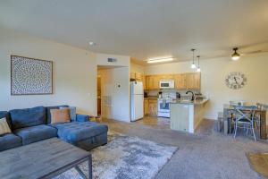 a living room with a blue couch and a kitchen at Coeur dAlene Vacation Rental 4 Mi to Hayden Lake in Coeur d'Alene