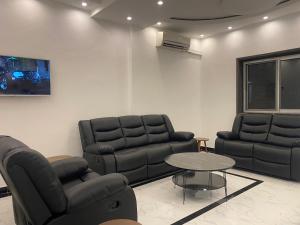 a living room with two couches and a table at Hôtel rotana in Brazzaville