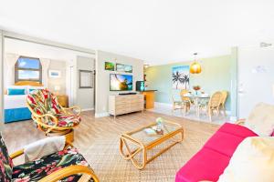 a living room with a couch and a table at Beautiful Mountain Views & Steps to Waikiki Beach in Honolulu