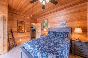 a bedroom with a bed in a log cabin at Cabin #5 Black Bear - Pet Friendly - Sleeps 6 - Playground & Game Room in Payson