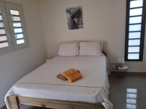 Een bed of bedden in een kamer bij L’envolée bleue