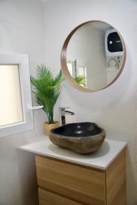 La salle de bains est pourvue d'un lavabo noir et d'un miroir. dans l'établissement El estudio de Jessica, à La Laguna