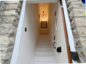 a stairway leading to a hallway with a stone wall at Converted Railway Cottage in Swindon