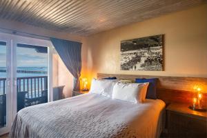 Inn At Avila Beach في أفيلا بيتش: غرفة نوم مع سرير وإطلالة على المحيط