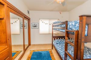 a room with two bunk beds and a doorway at Yellow Rose in Puerto Peñasco