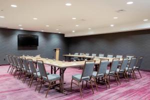 a conference room with a long table and chairs at Courtyard by Marriott New York Queens/Fresh Meadows in Queens
