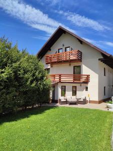 a large white house with a large yard at Pensiunea Antonio Bran in Bran +71 photos
