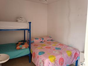 a small room with a bed and a bunk bed at hostal k in Valledupar